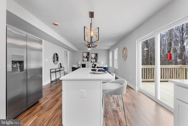 6955 Solomons Island Rd N, Sunderland, MD 20689 - kitchen featuring plenty of natural light, stainless steel refrigerator with ice dispenser, wood finished floors, and light countertops