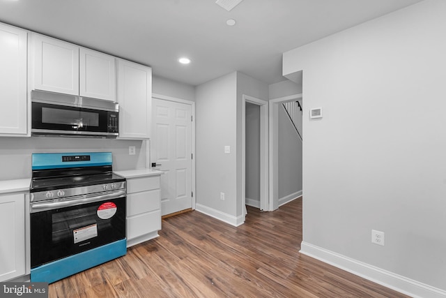 6955 Solomons Island Rd N, Sunderland, MD 20689 - kitchen featuring light wood-style flooring, white cabinetry, stainless steel appliances, and baseboards