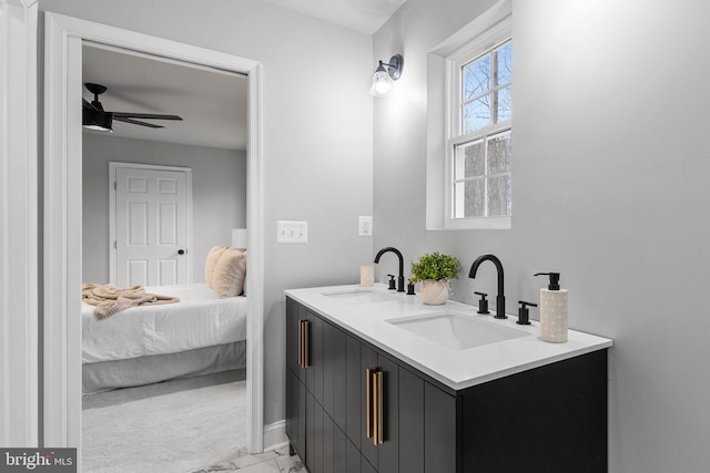 6955 Solomons Island Rd N, Sunderland, MD 20689 - ensuite bathroom featuring baseboards, a ceiling fan, double vanity, and a sink