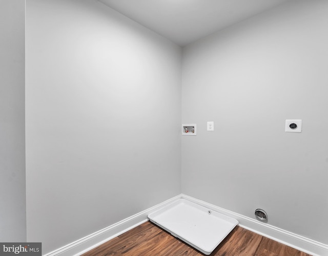 6955 Solomons Island Rd N, Sunderland, MD 20689 - clothes washing area featuring electric dryer hookup, baseboards, hookup for a washing machine, dark wood finished floors, and laundry area