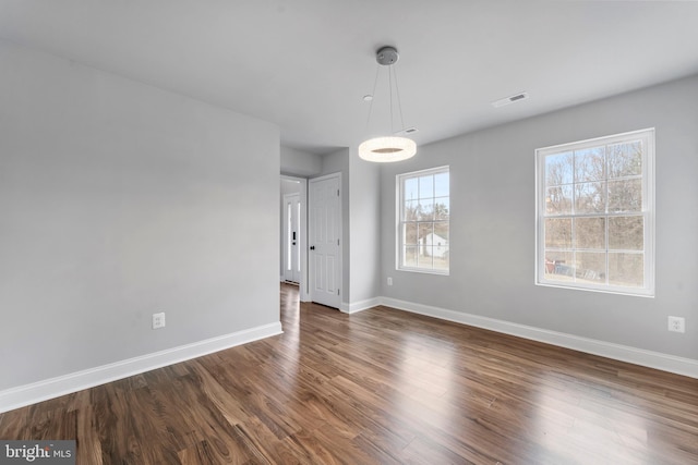 6955 Solomons Island Rd N, Sunderland, MD 20689 - unfurnished dining area featuring dark wood-style flooring, visible vents, and baseboards
