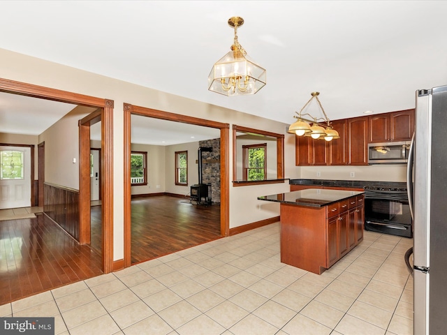 10433 Grindstone Run Rd, Myersville, MD 21773 - kitchen with appliances with stainless steel finishes, dark countertops, a chandelier, light wood-type flooring, and a center island