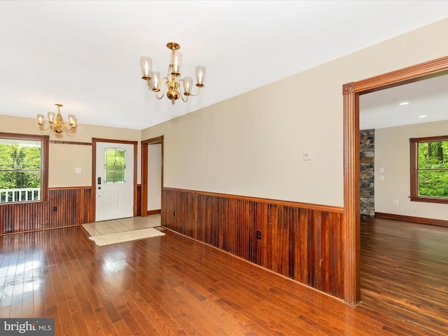 10433 Grindstone Run Rd, Myersville, MD 21773 - unfurnished room featuring a chandelier, hardwood / wood-style flooring, a wainscoted wall, and wooden walls