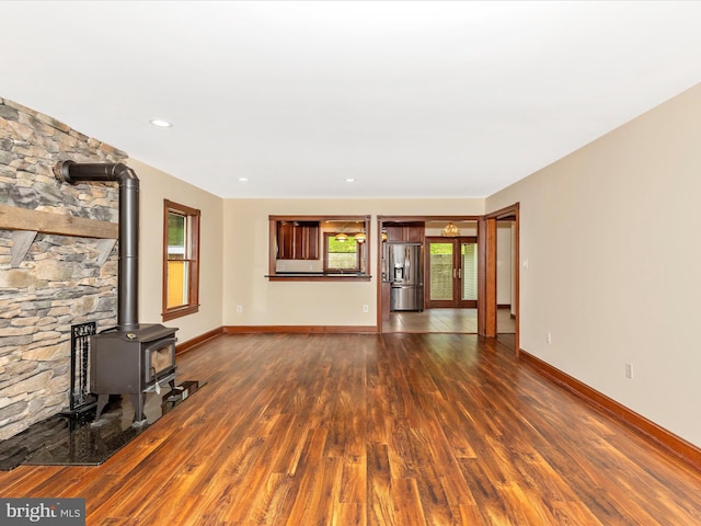 10433 Grindstone Run Rd, Myersville, MD 21773 - unfurnished living room with a wood stove, plenty of natural light, dark wood-style floors, and baseboards