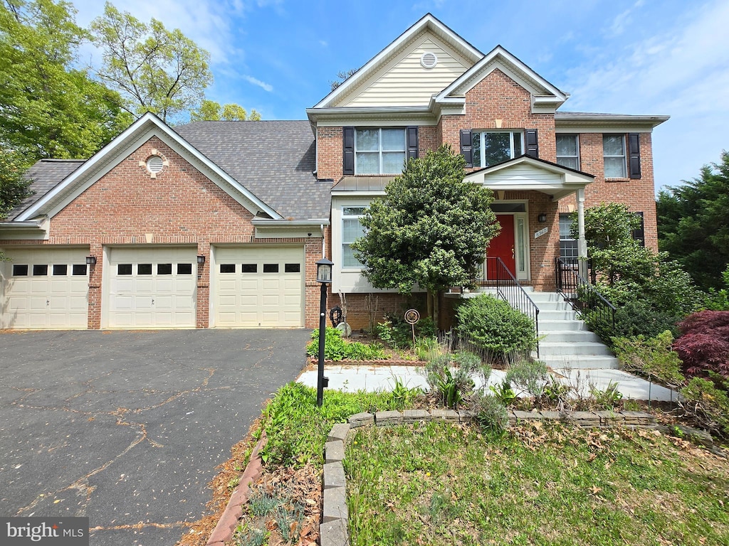 8910 Littleton St, Fairfax, VA 22032 - view of front of home featuring an attached garage, driveway, and brick siding