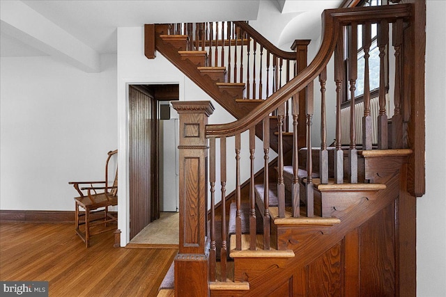 stairs with baseboards and wood finished floors