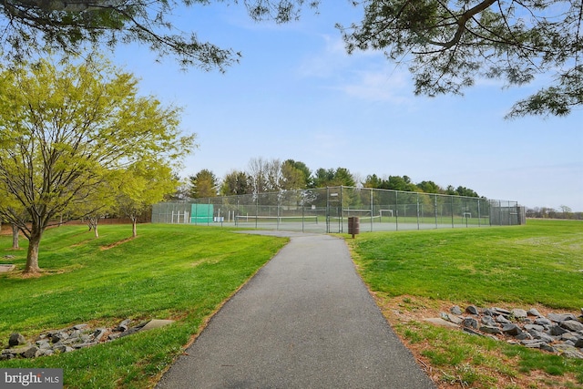view of home's community with a tennis court