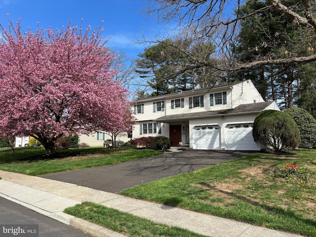 view of front of house with a front lawn and driveway