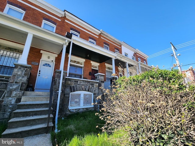 view of front of property with a porch and brick siding