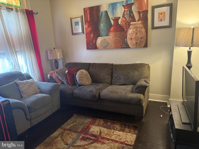 living area with wood finished floors and baseboards