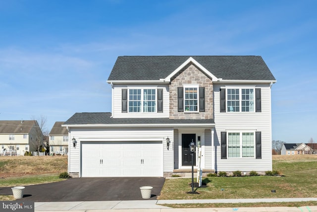 traditional home featuring stone siding, a shingled roof, driveway, and a front yard