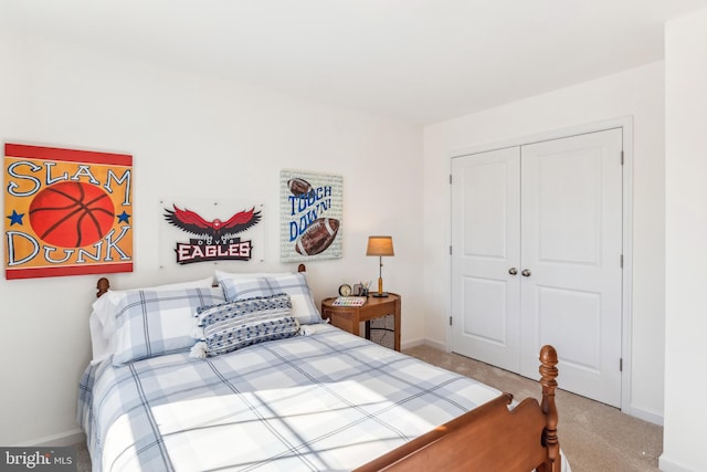bedroom with baseboards, a closet, and carpet