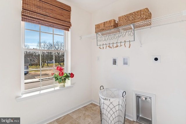 laundry room with electric dryer hookup, hookup for a washing machine, laundry area, and baseboards
