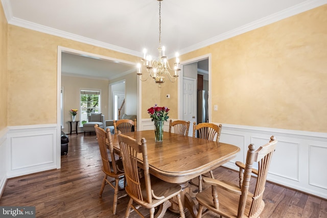 9804 Luck Penny Ct, Bristow, VA 20136 - dining area featuring a chandelier, dark wood-type flooring, a wainscoted wall, ornamental molding, and a decorative wall