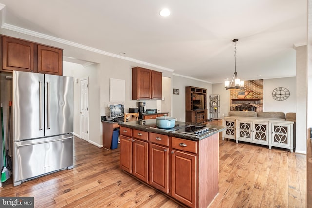 9804 Luck Penny Ct, Bristow, VA 20136 - kitchen with high end fridge, light wood-style flooring, black electric stovetop, dark countertops, and crown molding