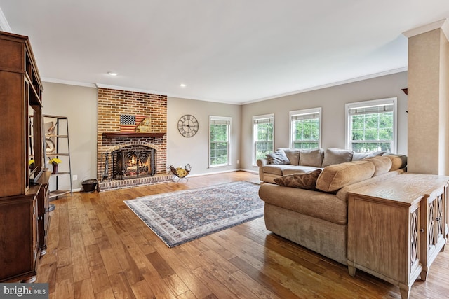 9804 Luck Penny Ct, Bristow, VA 20136 - living room featuring hardwood / wood-style floors, a fireplace, ornamental molding, and recessed lighting