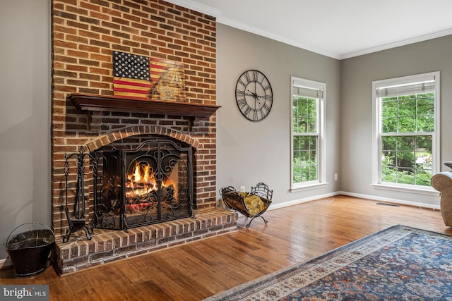 9804 Luck Penny Ct, Bristow, VA 20136 - living room with hardwood / wood-style flooring, a brick fireplace, baseboards, and crown molding