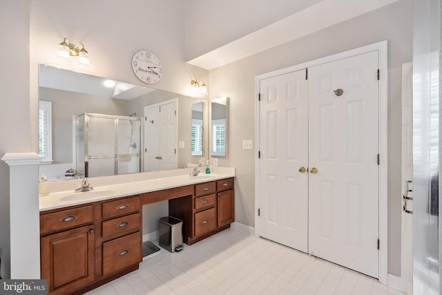 9804 Luck Penny Ct, Bristow, VA 20136 - full bath featuring a shower stall, tile patterned floors, double vanity, and baseboards