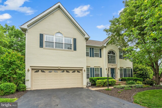 9804 Luck Penny Ct, Bristow, VA 20136 - view of front of home featuring asphalt driveway and a garage