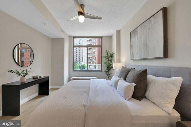 3600 S Glebe Rd Unit 321W, Arlington, VA 22202 - bedroom featuring light wood-type flooring, ceiling fan, baseboards, and a textured ceiling
