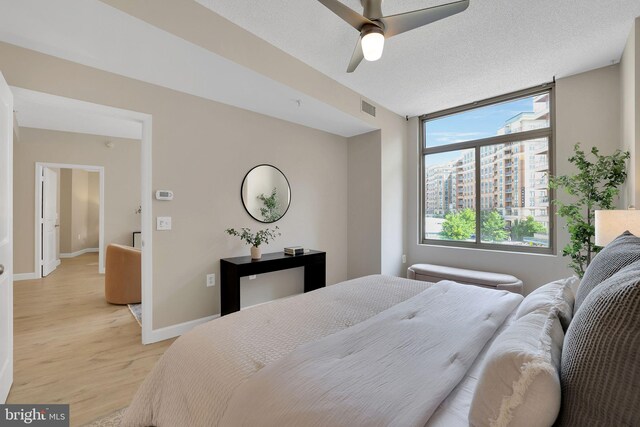 3600 S Glebe Rd Unit 321W, Arlington, VA 22202 - bedroom with light wood-type flooring, baseboards, and a ceiling fan