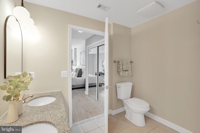 3600 S Glebe Rd Unit 321W, Arlington, VA 22202 - bathroom with toilet, connected bathroom, tile patterned flooring, vanity, and baseboards