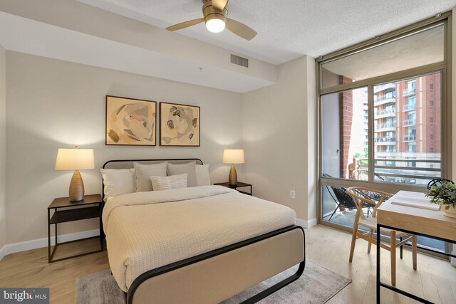 3600 S Glebe Rd Unit 321W, Arlington, VA 22202 - bedroom with access to exterior, baseboards, light wood-type flooring, a ceiling fan, and a textured ceiling