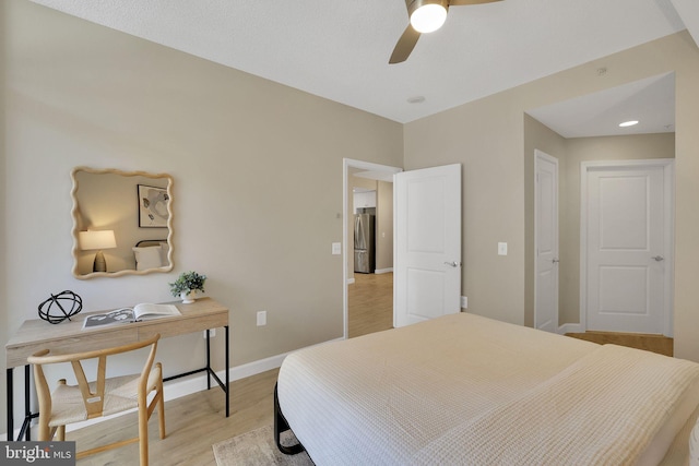 3600 S Glebe Rd Unit 321W, Arlington, VA 22202 - bedroom with freestanding refrigerator, light wood-style floors, baseboards, and a ceiling fan