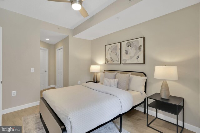 3600 S Glebe Rd Unit 321W, Arlington, VA 22202 - bedroom with light wood finished floors, baseboards, ceiling fan, and a closet