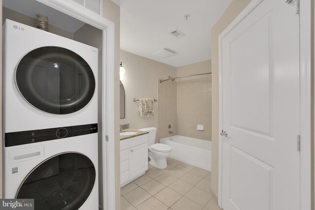 3600 S Glebe Rd Unit 321W, Arlington, VA 22202 - bathroom featuring stacked washing machine and dryer, tile patterned floors, toilet, vanity, and washtub / shower combination