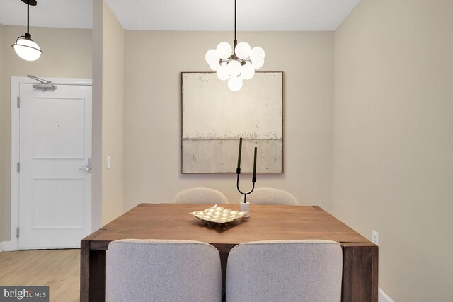 3600 S Glebe Rd Unit 321W, Arlington, VA 22202 - dining area featuring a chandelier, wood finished floors, and baseboards