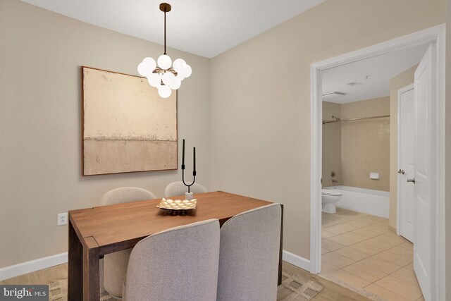 3600 S Glebe Rd Unit 321W, Arlington, VA 22202 - dining space with a chandelier, baseboards, and light tile patterned floors