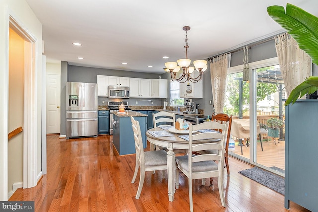dining space featuring an inviting chandelier, recessed lighting, and light wood finished floors