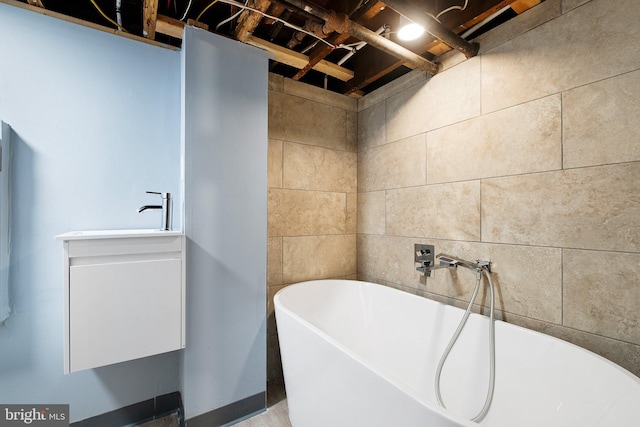 full bath with a soaking tub and a sink