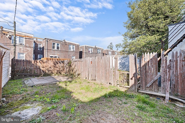 view of yard featuring fence and a residential view