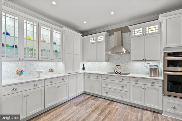 525 Belmont Bay Dr Unit 405, Woodbridge, VA 22191 - kitchen featuring ornamental molding, double oven, wall chimney exhaust hood, light countertops, and black electric cooktop