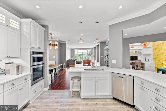 525 Belmont Bay Dr Unit 405, Woodbridge, VA 22191 - kitchen with a sink, ornamental molding, open floor plan, and appliances with stainless steel finishes