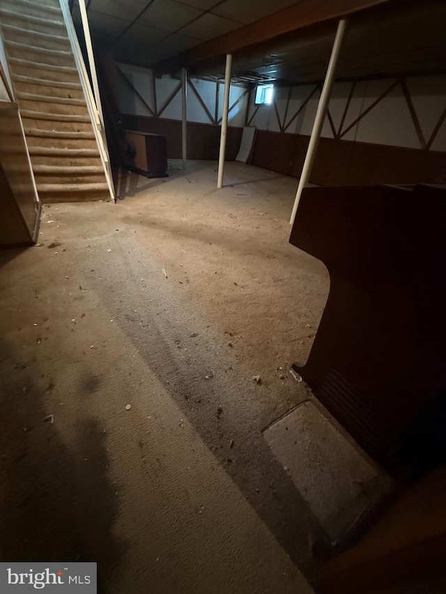 unfinished basement featuring stairs