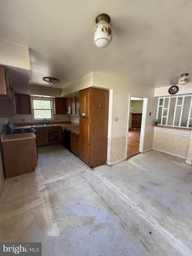 kitchen with a sink, dishwasher, and open floor plan