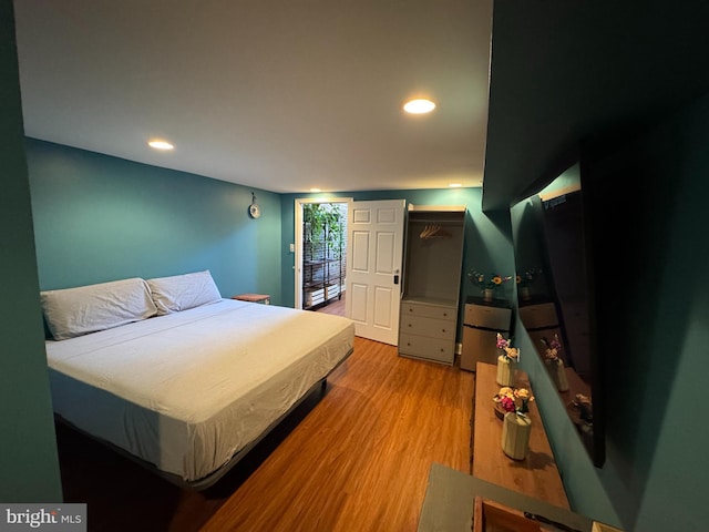 bedroom with recessed lighting and wood finished floors