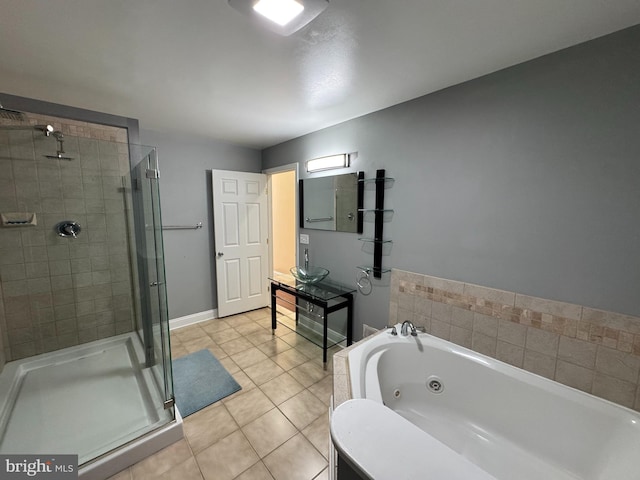full bath with a jetted tub, a shower stall, tile patterned floors, vanity, and baseboards
