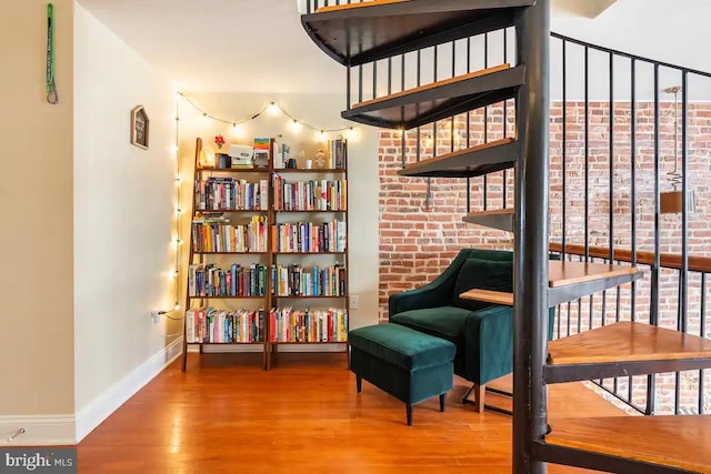 sitting room featuring baseboards and wood finished floors