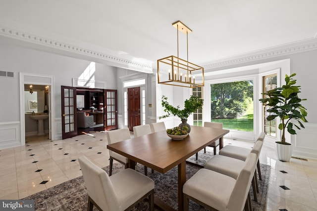 1418 Woodhurst Blvd, Mclean, VA 22102 - dining area with a decorative wall, light tile patterned floors, ornamental molding, wainscoting, and a chandelier
