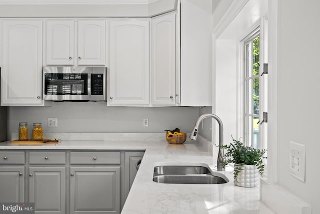 1418 Woodhurst Blvd, Mclean, VA 22102 - kitchen with stainless steel microwave, a sink, gray cabinetry, and white cabinets