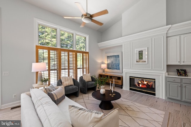 1418 Woodhurst Blvd, Mclean, VA 22102 - living room with high vaulted ceiling, a ceiling fan, a glass covered fireplace, and baseboards