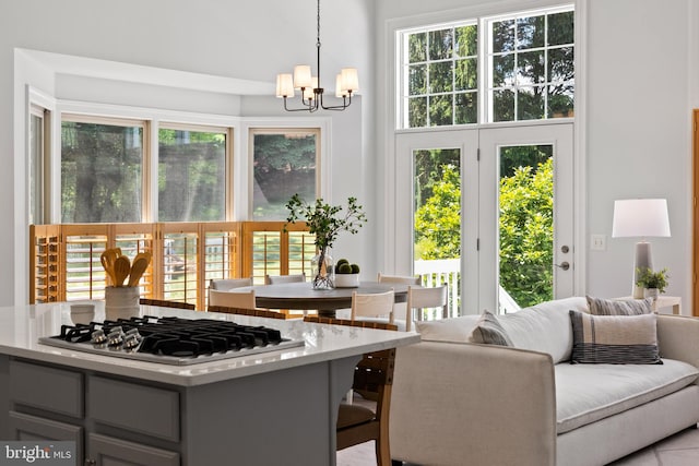 1418 Woodhurst Blvd, Mclean, VA 22102 - kitchen with stainless steel gas cooktop, a chandelier, plenty of natural light, hanging light fixtures, and a towering ceiling