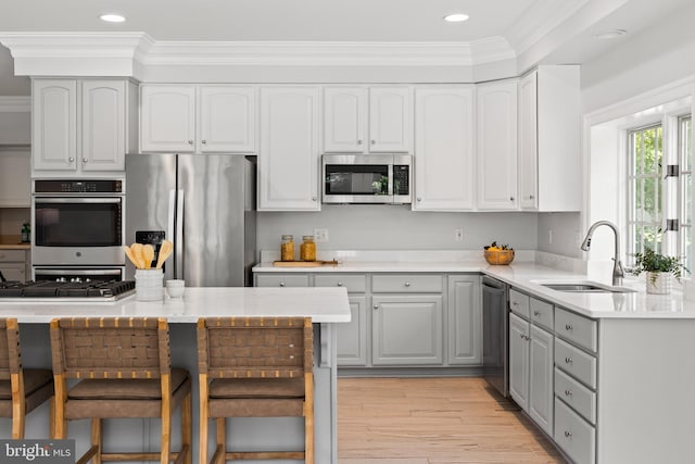 1418 Woodhurst Blvd, Mclean, VA 22102 - kitchen with stainless steel appliances, a sink, ornamental molding, light wood-type flooring, and recessed lighting