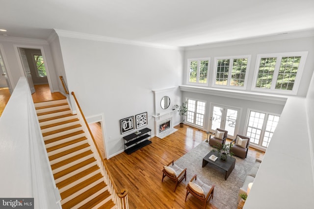 1418 Woodhurst Blvd, Mclean, VA 22102 - living room with wood finished floors, ornamental molding, a fireplace with flush hearth, stairway, and baseboards