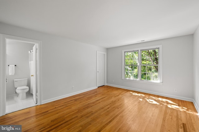 1418 Woodhurst Blvd, Mclean, VA 22102 - unfurnished bedroom with wood finished floors, baseboards, and connected bathroom