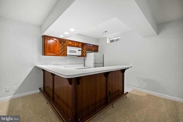 1418 Woodhurst Blvd, Mclean, VA 22102 - kitchen featuring white appliances, baseboards, light colored carpet, a breakfast bar, and a peninsula